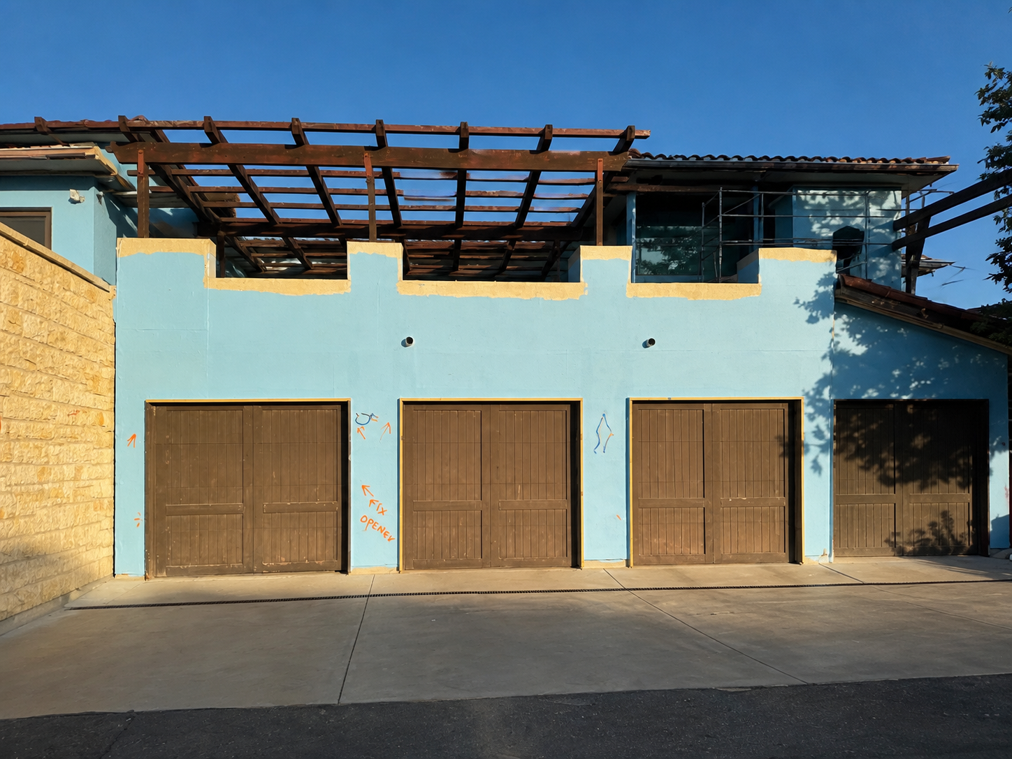 Garage facade after blue waterproofing membrane was applied
